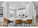 Stylish kitchen featuring a marble countertop island with seating, white cabinetry, and stainless steel appliances at 10003 Brompton Dr, Tampa, FL 33626