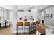 Bright, modern kitchen with stainless steel appliances, white cabinets, and a marble countertop island with seating at 10003 Brompton Dr, Tampa, FL 33626
