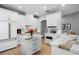 Well-equipped kitchen with white cabinets, marble countertops, and modern appliances, plus a beverage cooler at 10003 Brompton Dr, Tampa, FL 33626