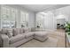 Bright living room with neutral walls, sectional sofa, plantation shutters, and wood-look floors at 10003 Brompton Dr, Tampa, FL 33626