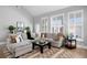 Cozy living room showcasing a comfortable sectional sofa, large windows with shutters, and stylish decor at 10003 Brompton Dr, Tampa, FL 33626