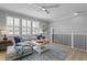 Bright living room with large windows, a ceiling fan, and comfortable seating at 10003 Brompton Dr, Tampa, FL 33626