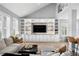 Open living room features soaring ceilings, a fireplace, a built-in entertainment center, and natural light at 10003 Brompton Dr, Tampa, FL 33626