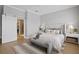 Spacious bedroom with light wood floors, a sliding barn door, and stylish decor at 10003 Brompton Dr, Tampa, FL 33626