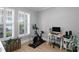 Bright office space with plantation shutters, neutral paint, desk, computer, and exercise bike at 10003 Brompton Dr, Tampa, FL 33626