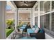 Inviting covered patio with comfortable seating and views of the well-maintained backyard at 10003 Brompton Dr, Tampa, FL 33626