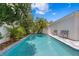 A refreshing pool with a paver patio is surrounded by lush greenery, ideal for relaxation and leisure at 10003 Brompton Dr, Tampa, FL 33626