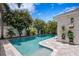 Beautiful pool area featuring a well-maintained pool, brick pavers, and lush landscaping, perfect for outdoor relaxation and entertaining at 10003 Brompton Dr, Tampa, FL 33626