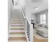 Staircase with light wood treads and white risers, leading to a living area at 10003 Brompton Dr, Tampa, FL 33626