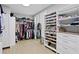 Spacious walk-in closet with custom shelves, drawers, and ample hanging space at 10003 Brompton Dr, Tampa, FL 33626