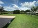 Fenced backyard features lush grass and a picturesque view of a tranquil pond at 1008 Arista Blvd, Valrico, FL 33594