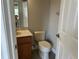 Cozy bathroom with single sink vanity, toilet, medicine cabinet, and tile flooring at 1008 Arista Blvd, Valrico, FL 33594