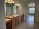 Bathroom featuring double vanity with granite countertop and tiled floor at 1008 Arista Blvd, Valrico, FL 33594