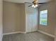 Bright bedroom featuring wood-look flooring, neutral walls, a ceiling fan, and a window at 1008 Arista Blvd, Valrico, FL 33594