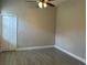 Simple bedroom with neutral paint, tile flooring, white baseboards, and a double door closet at 1008 Arista Blvd, Valrico, FL 33594