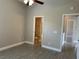 Bedroom showcasing an open doorway to a bathroom with neutral paint and tile flooring at 1008 Arista Blvd, Valrico, FL 33594