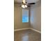 This bedroom features a window with blinds, a ceiling fan, and tile flooring at 1008 Arista Blvd, Valrico, FL 33594