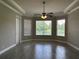 Main bedroom with tiled floor and natural light from windows overlooking the backyard at 1008 Arista Blvd, Valrico, FL 33594