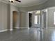 Foyer area featuring columns, decorative front door, and view into the living room at 1008 Arista Blvd, Valrico, FL 33594