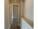 Hallway showcasing an open doorway to a room with neutral paint and tile flooring at 1008 Arista Blvd, Valrico, FL 33594