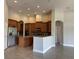 Kitchen featuring wood cabinets, stainless steel appliances, island and tile floor at 1008 Arista Blvd, Valrico, FL 33594