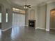 Open living room featuring a fireplace, high ceilings and access to the backyard at 1008 Arista Blvd, Valrico, FL 33594