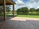 Relax on this brick patio with views of a tranquil pond surrounded by mature trees at 1008 Arista Blvd, Valrico, FL 33594