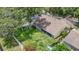 Spacious backyard with a mix of green grass and a large shade tree for outdoor enjoyment at 10206 Evening Trail Dr, Riverview, FL 33569