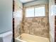 Bathroom featuring tiled shower and window at 10206 Evening Trail Dr, Riverview, FL 33569