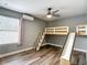 Bedroom with hardwood floors, built in bunk and slide and ceiling fan at 10206 Evening Trail Dr, Riverview, FL 33569