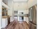 Bright, open kitchen with stainless steel appliances, granite countertops and wood look floors at 10206 Evening Trail Dr, Riverview, FL 33569