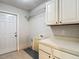 Laundry room featuring cabinets, countertop and exterior door at 10206 Evening Trail Dr, Riverview, FL 33569