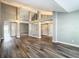 Open-concept living room featuring stylish LVP flooring and modern color scheme at 10206 Evening Trail Dr, Riverview, FL 33569