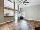 Bright living room featuring high ceilings, modern ceiling fan, and wood-look floors at 10206 Evening Trail Dr, Riverview, FL 33569