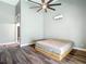This main bedroom boasts stylish wood floors, a modern ceiling fan and ensuite bathroom at 10206 Evening Trail Dr, Riverview, FL 33569