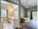 Main bedroom with ensuite bathroom, ceiling fan and sliding door access to the backyard at 10206 Evening Trail Dr, Riverview, FL 33569