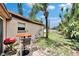 Cozy backyard with an outdoor seating area, grill, and lush tropical plants, perfect for entertaining at 10549 112Th Ave, Largo, FL 33773