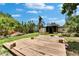 Expansive wooden deck in a lush backyard offers space for entertaining and enjoying outdoor living at 10549 112Th Ave, Largo, FL 33773