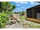 Lush backyard with a stone table set, wooden deck, and outdoor cabana, ideal for outdoor activities at 10549 112Th Ave, Largo, FL 33773