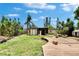 Spacious backyard featuring lush tropical landscaping, wooden deck and unique cabana at 10549 112Th Ave, Largo, FL 33773