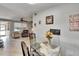 A view of the open concept shows the dining area looking into the living room with cozy seating at 10549 112Th Ave, Largo, FL 33773