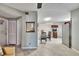 Open dining area with a glass table, black chairs, and wood-look tile flooring connects to the kitchen at 10549 112Th Ave, Largo, FL 33773