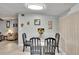 Bright dining area with a glass table and black chairs with decorative art pieces at 10549 112Th Ave, Largo, FL 33773