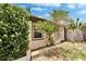 Side view of a single-Gathering home showing windows, siding, foliage, and a weathered wooden fence at 10549 112Th Ave, Largo, FL 33773