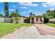 Charming single-story home featuring a well-maintained lawn and brick-paved walkway at 10549 112Th Ave, Largo, FL 33773