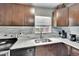 Kitchen featuring dark wood cabinets, marble countertops, tile backsplash, and stainless appliances at 10549 112Th Ave, Largo, FL 33773