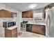 Kitchen features dark wood cabinets, marble countertops, tile backsplash, and stainless appliances at 10549 112Th Ave, Largo, FL 33773