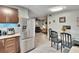 A view of the kitchen with stainless steel appliances, cabinets, and a dining area with seating at 10549 112Th Ave, Largo, FL 33773