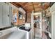 A laundry room with a washer and dryer, with a partial view of the kitchen, and storage cabinets at 10549 112Th Ave, Largo, FL 33773