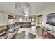 Well-lit living room featuring tile floors, contemporary furniture, and a ceiling fan at 10549 112Th Ave, Largo, FL 33773